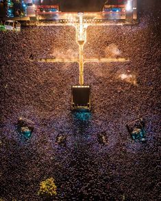 an aerial view of a concert with lots of people in the audience and lights on