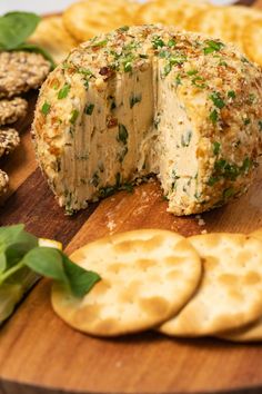 a cheese ball on a cutting board with crackers