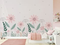 a child's bedroom with pink and green flowers on the wall