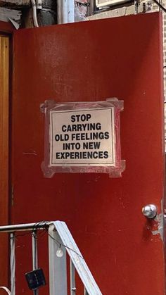 a red door with a sign on it stating stop carrying old items to new experiences