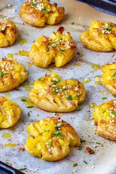 baked potatoes with herbs and seasoning on a baking sheet