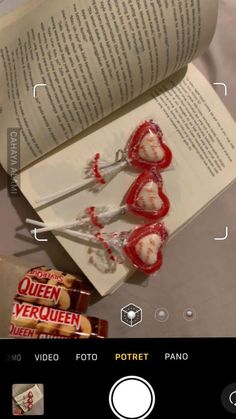 an open book with candy on top of it