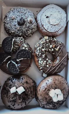 a box filled with assorted donuts covered in chocolate and marshmallows