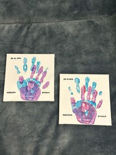 two pieces of paper with handprints on them sitting next to eachother