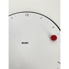 an analog clock with the word moma on it's face and red push button