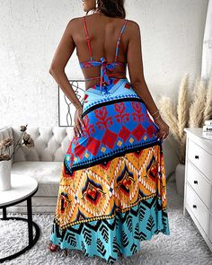 Woman wearing multicolor tribal print crop top and long flowy skirt Bohemian Multicolor Bottoms For Vacation, Bohemian Multicolor Bottoms For Beach Party, Multicolor Bohemian Bottoms For Beach Party, Summer Beach Printed Maxi Skirt, Casual Beach Season Skirt For Vacation, Summer Beach Boho Print Bottoms, Vibrant Blue Bottoms For Vacation, Flowy Printed Maxi Skirt For Beach, Summer Vacation Boho Print Bottoms