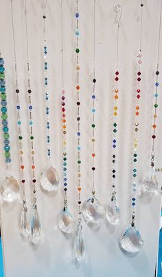 a bunch of beads hanging from the side of a wall