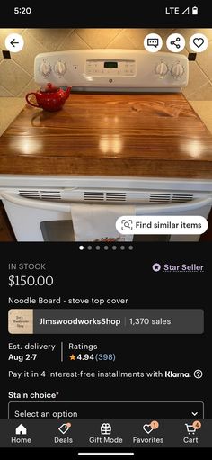 a white stove top oven sitting on top of a wooden counter