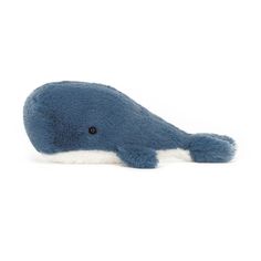 a blue stuffed whale laying on its side