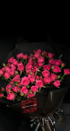 a bouquet of pink roses sitting on top of a table