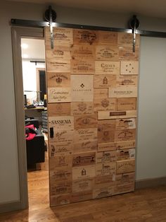 a door made out of wine corks in a room with hardwood floors and walls