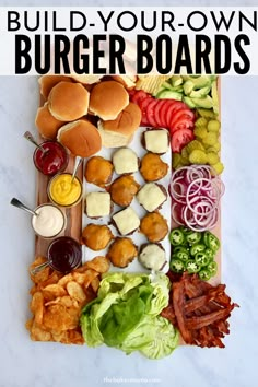 a wooden cutting board topped with burgers and lettuce next to other foods