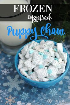 a blue bowl filled with puppy chow next to a glass of milk