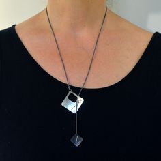 Every day is an opportunity to express who you are. That’s why we designed our Two-Layered Stitched Square Necklace to match your mood! Each Argentium silver square is stitched with fine silver and hangs from an oxidized silver rope chain with a clasp in the back. This versatile necklace can be worn with the small square hanging lower than the larger square or with the two squares nestled together. It’s up to you! Details: Oxidized Argentium silver Bright Argentium silver 22” Oxidized silver rop Sterling Silver Square Pendant Necklace, Modern Metal Necklace With Square Pendant, Silver Necklace With Oxidized Finish And Square Pendant, Silver Brass Necklace With Square Pendant, Unique Soldered Square Pendant Necklace, Oxidized Silver Earrings, Silver Rope Chain, Fluid Design, Square Necklace