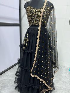 Designer black net ruffle indian wedding bridesmaid readymade lehenga choli for women or girls. Lehenga fabric: Net Blouse fabric : Raw silk Dupatta : net dupatta with sequin work Work : sequin-pearl work, ruffle style lehenga Blouse : Unstitch Lehenga : Semi Stitch Lehenga waist : Fits up to 42 waist  Bust size: Fits up to 44 waist  In plus size : fit up to 50. 👉 The flair of the lehenga will usually be 3.5 meter for free size but it will change according to your waist fitting. Our products ar Party Wear Net Sharara For Festivals, Semi-stitched Net Sharara Floor-length, Black Organza Sets For Reception, Black Self Design Dress For Party, Black Floor-length Traditional Wear With Self Design, Black Bollywood Dress With Self Design, Black Self-design Dress For Party, Party Anarkali Set With Pallu In Net Material, Party Anarkali Set In Net