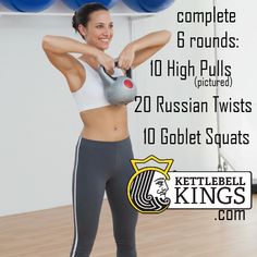 a woman holding a kettle while standing in front of blue boxing balls with the words kettlebell king on it