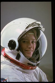 a woman wearing a helmet and smiling for the camera