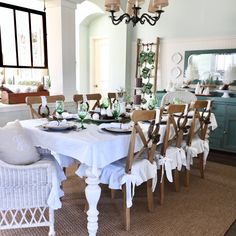 a dining room table is set with white linens