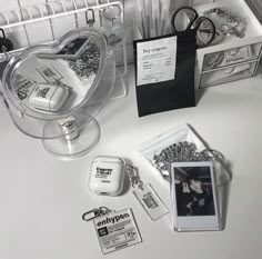 the contents of a jewelry box are neatly organized and displayed on a white countertop