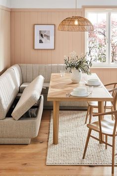 a living room filled with furniture and a wooden table