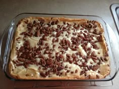 a pie with pecans on top in a pan