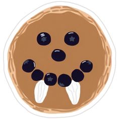 a chocolate chip cookie with black eyes and white wings on it's face is shown