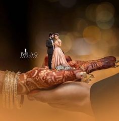 the bride and groom are posed on top of each other's hand with their wedding rings