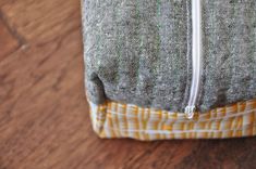 a zippered pouch sitting on top of a wooden table