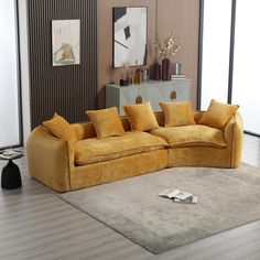 a yellow couch sitting on top of a rug in a living room