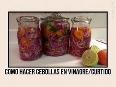 three jars filled with food sitting on top of a counter next to fruit and vegetables