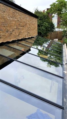 the roof of a building with glass on it