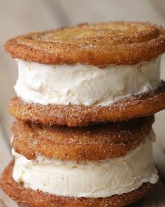 three desserts stacked on top of each other with whipped cream and cinnamon sprinkles