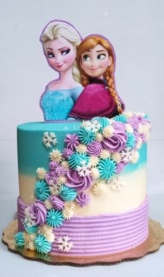 there is a cake decorated with two frozen princesses