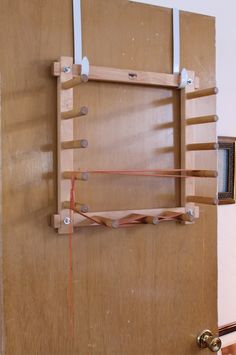 a wooden door with some wires attached to it and a window in the wall behind it