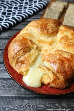 a red plate topped with bread and cheese