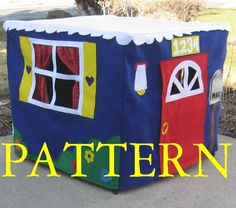 a toy house made to look like it is painted blue with red and yellow doors