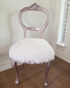 a white chair sitting on top of a hard wood floor