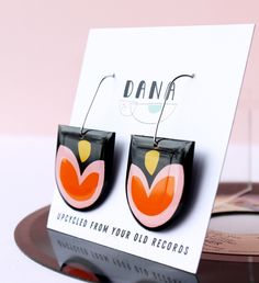 "Upcycled from an old vinyl record that was headed for landfill, these quirky earrings are a great present for vinyl lovers, sustainable fashion and art enthusiasts or anyone on the lookout for that bold unique handmade accessory. * D E T A I L S * ▹ hooks are stainless steel (nickel free, hypoallergenic, tarnish free) ▹ surprisingly lightweight and comfortable to wear ▹coated with a plant based resin ▹the back of the earrings is left untouched so you can appreciate the vinyl record in all its g Analog Collage, Old Vinyl Records, Quirky Earrings, Paper Earrings, Festival Diy, Art Earrings, Rose Orange, Recycled Jewelry, Earring Cards