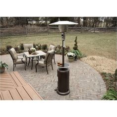 an outdoor patio with chairs, table and fire pit in the middle of it's yard