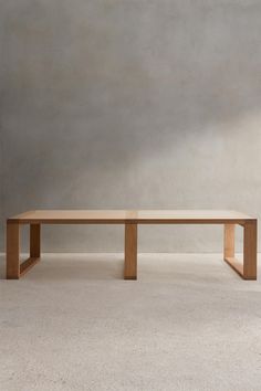 a wooden bench sitting on top of a white carpeted floor next to a wall