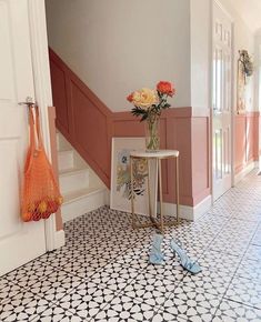 there is a vase with flowers in it on the floor