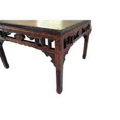 an old wooden table with carvings on the top and bottom, against a white background