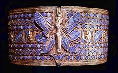 an elaborately decorated bracelet with blue stones and metal details on the outside of it