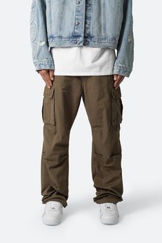 the Ultra Baggy Vintage Cargo Pants are designed with an oversized, relaxed fit throughout with gusseting at the knee, cargo pockets at the side seam, a cinch-able waistband, zipper fly, and finishing off with elastic and cargo drawcords at the leg openings. details baggy fit 100% cotton zipper fly drawcords at leg opening model is 6’1, 160 lbs and wears a size 30 note: this fit is intentionally baggy in waist and fit, for a more relaxed fit we recommend sizing down Olive Pants Men, Vintage Cargo Pants, Layered Hoodie, Olive Pants, Pants Outfit Men, Moto Pants, Green Cargo Pants, Baggy Trousers, Denim Flares