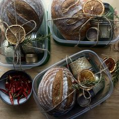 three plastic containers filled with food on top of a wooden table and covered in twine