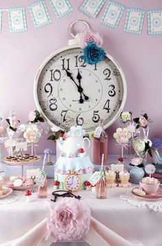 a table topped with a cake and a large clock