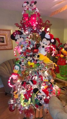 a christmas tree decorated with mickey mouse ornaments