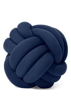 a blue knot pillow sitting on top of a white floor