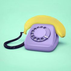 an old fashioned phone with a banana on the front and bottom receiver, sitting on a blue background