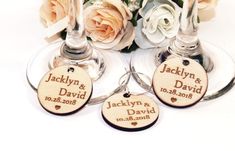 three wine glasses with wedding date tags on them